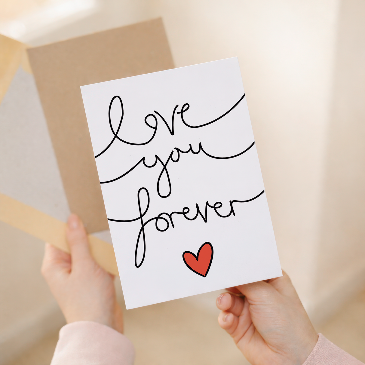 Elegant anniversary or Valentine's Day greeting card featuring the message Love You Forever in stylish script on sustainable cardstock, paired with a brown Kraft envelope.