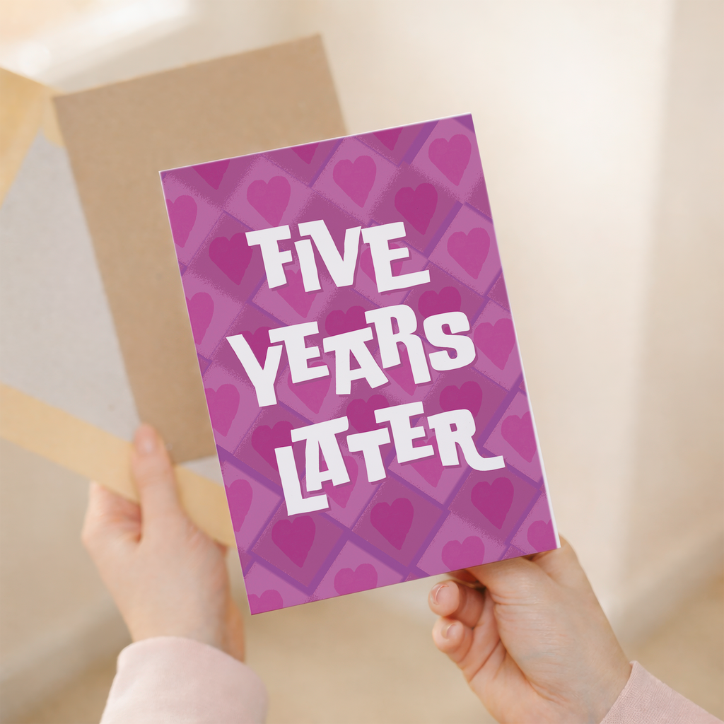 Minimalist 5th Wedding Anniversary greeting card featuring a large, stylized number five adorned with pink and purple floral patterns on eco-friendly cardstock, accompanied by a brown Kraft envelope.