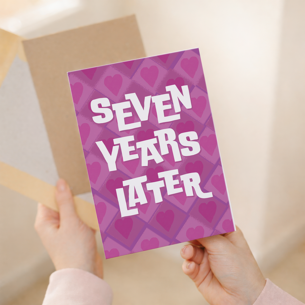 Elegant 7th Wedding Anniversary greeting card featuring a modern design in pink, white, and purple on sustainable recycled cardstock, paired with a classic brown Kraft envelope.