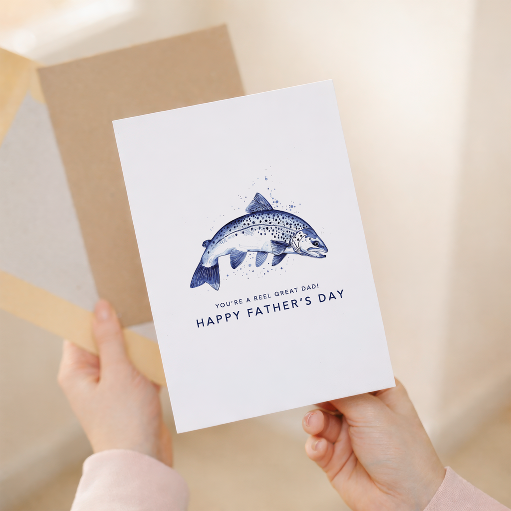 A simple and minimalist Father's Day greeting card featuring a blue fishing hook illustration on a white background with the text You are a reel catch.
