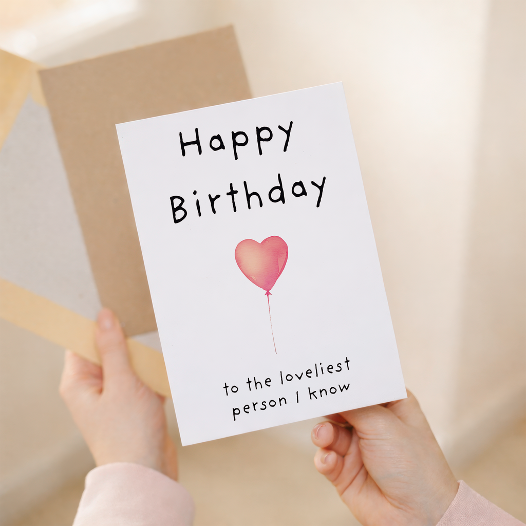 Charming birthday greeting card featuring a central floral heart illustration on sustainable recycled cardstock, paired with a brown Kraft envelope.