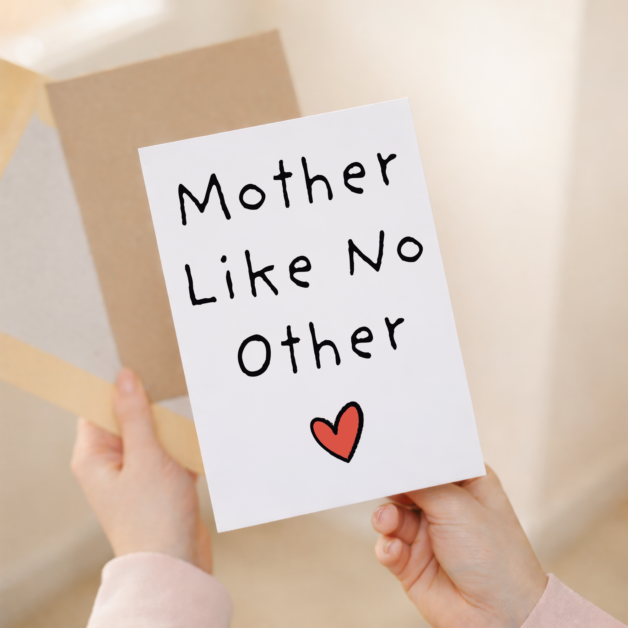 Elegant Mother's Day greeting card featuring a floral design with red and pink details on white sustainable cardstock, paired with a rustic brown Kraft envelope.