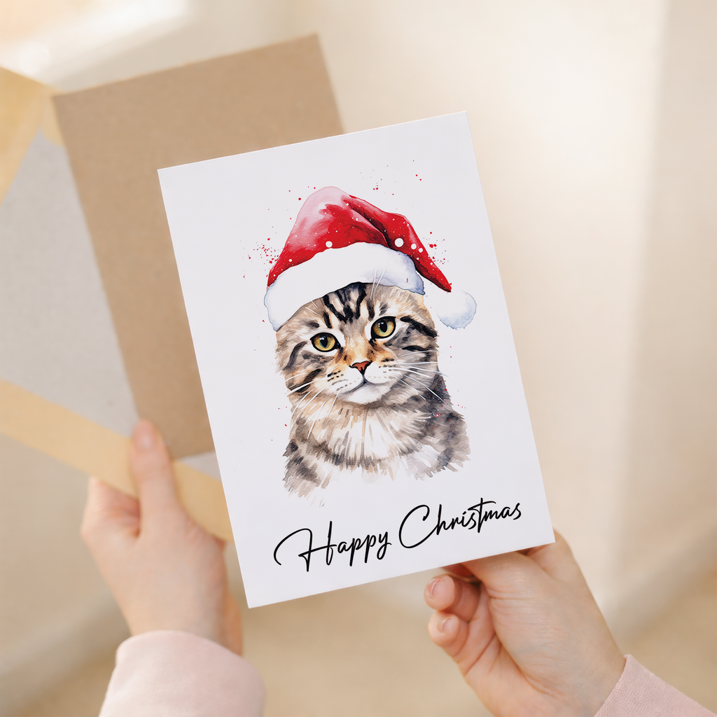 Festive Christmas greeting card featuring a cute tabby cat wearing a red and white Santa hat.