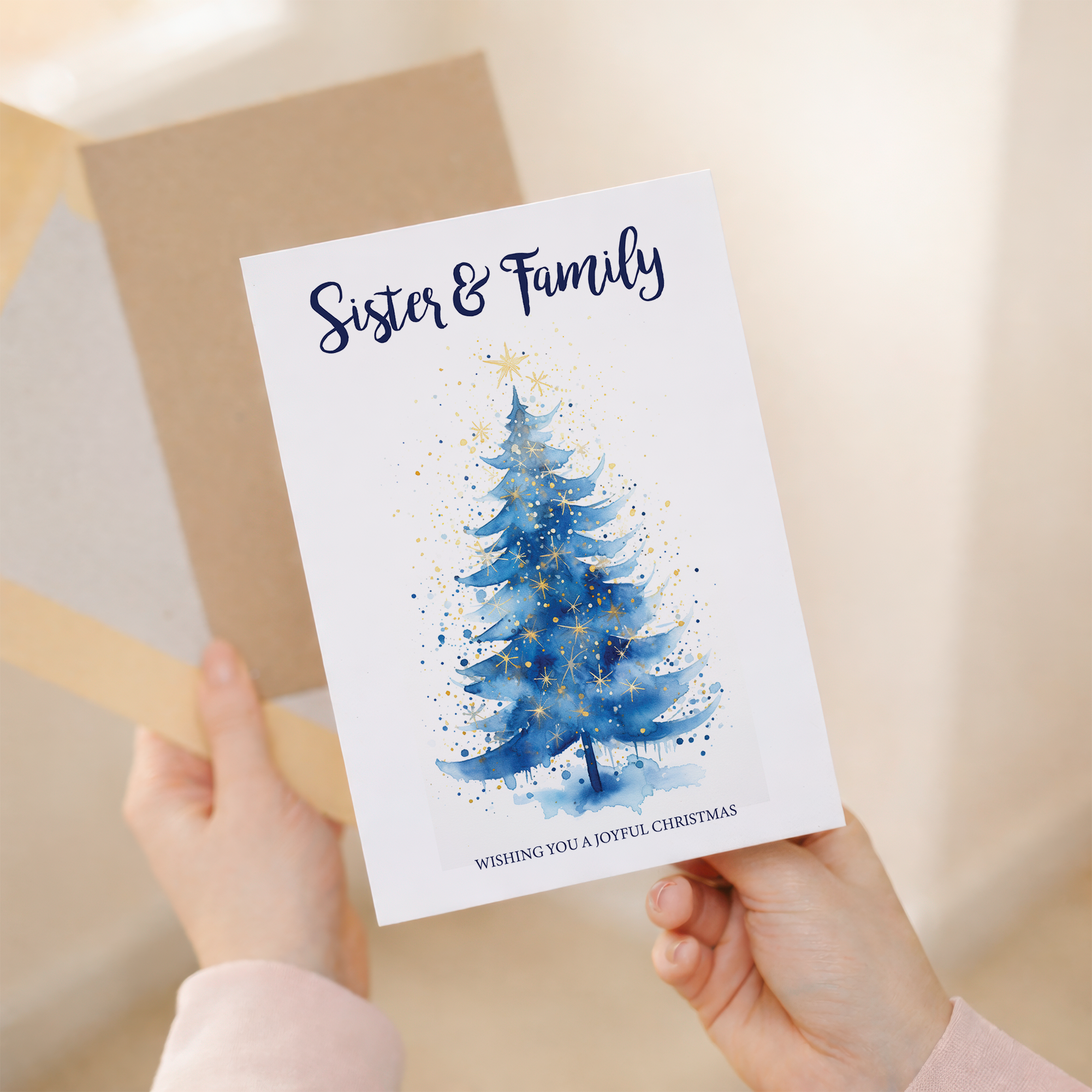 Festive Christmas card featuring a minimalist illustration of three Christmas trees in different shades of green, with a "Sister & Family" greeting at the bottom.