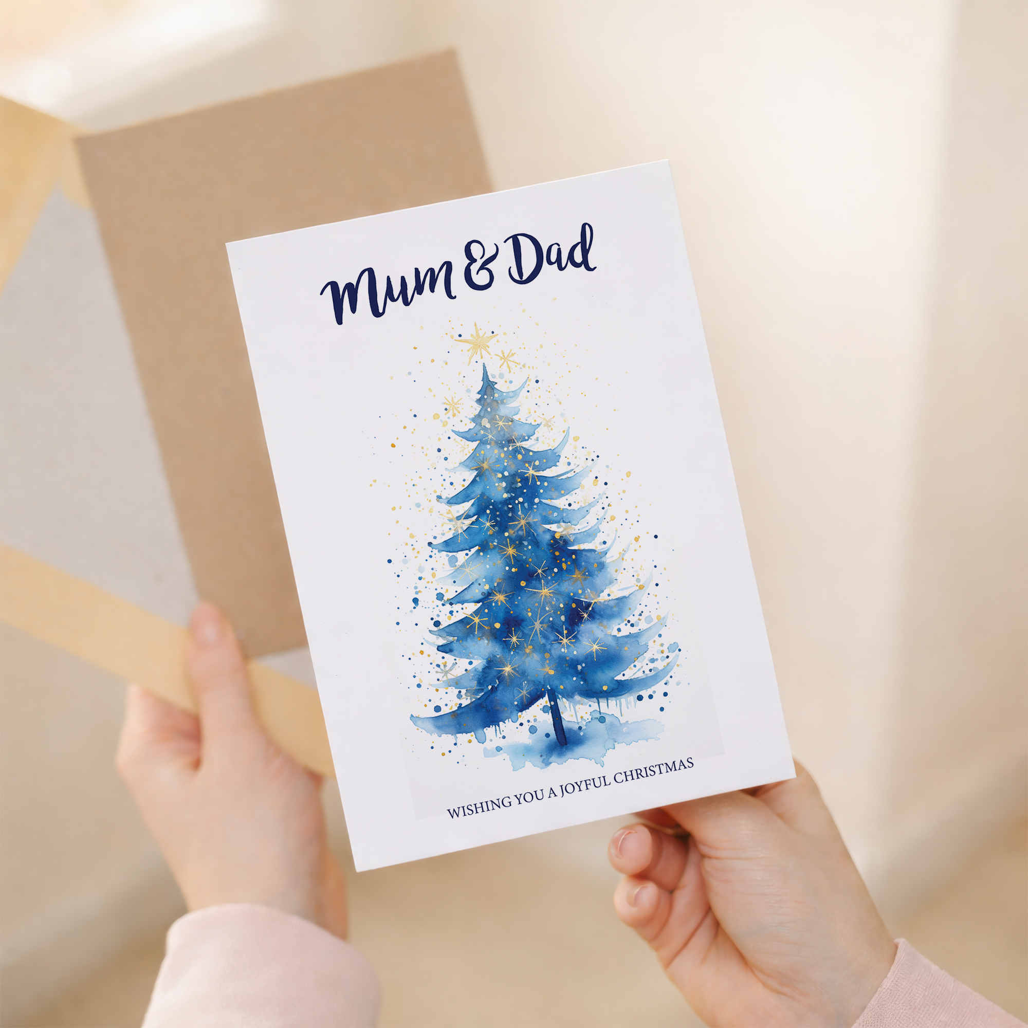Christmas card featuring a minimalist illustration of a decorated Christmas tree, with a kraft envelope.