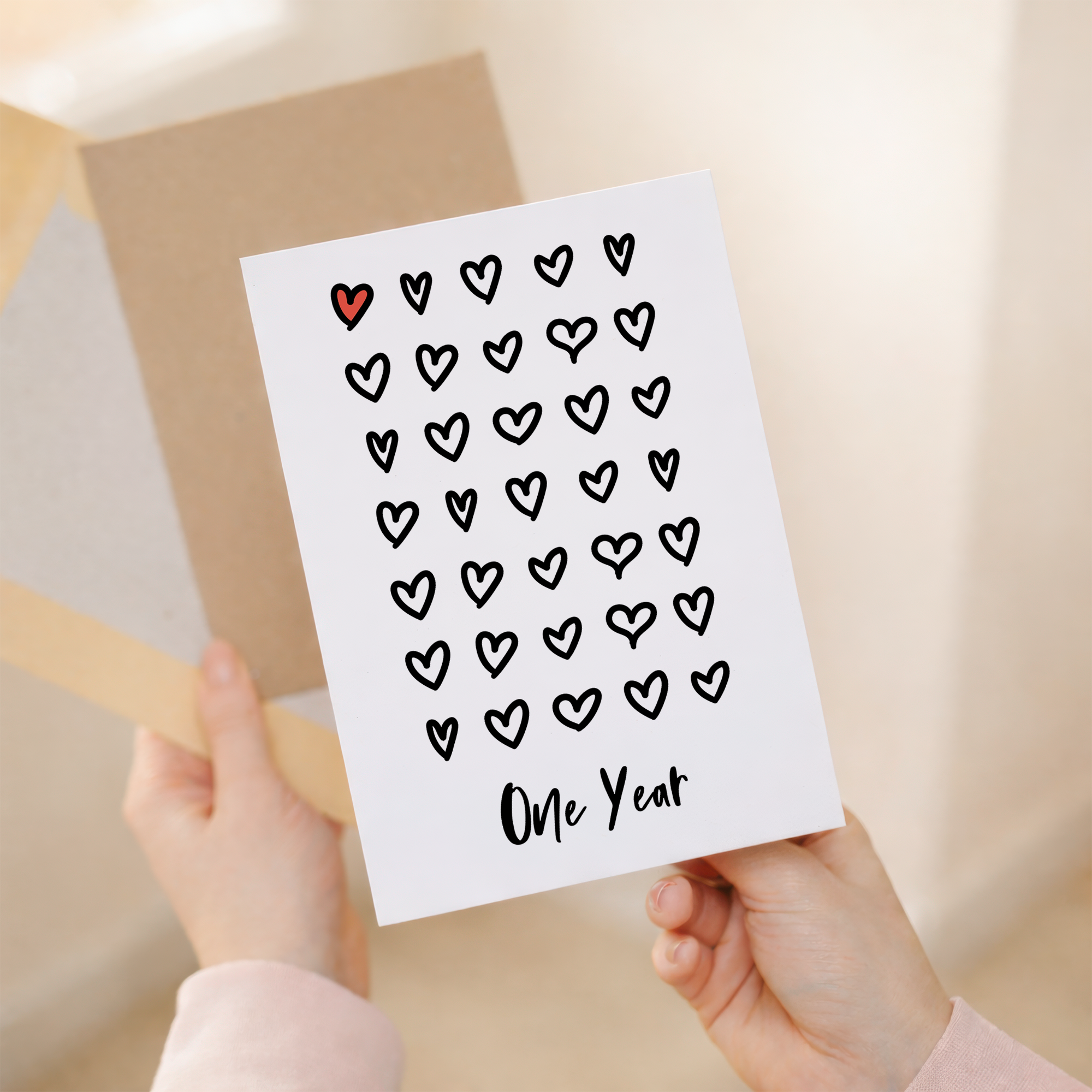 Elegant 1st Wedding Anniversary greeting card with a romantic design on sustainable recycled cardstock, accompanied by a brown Kraft envelope.