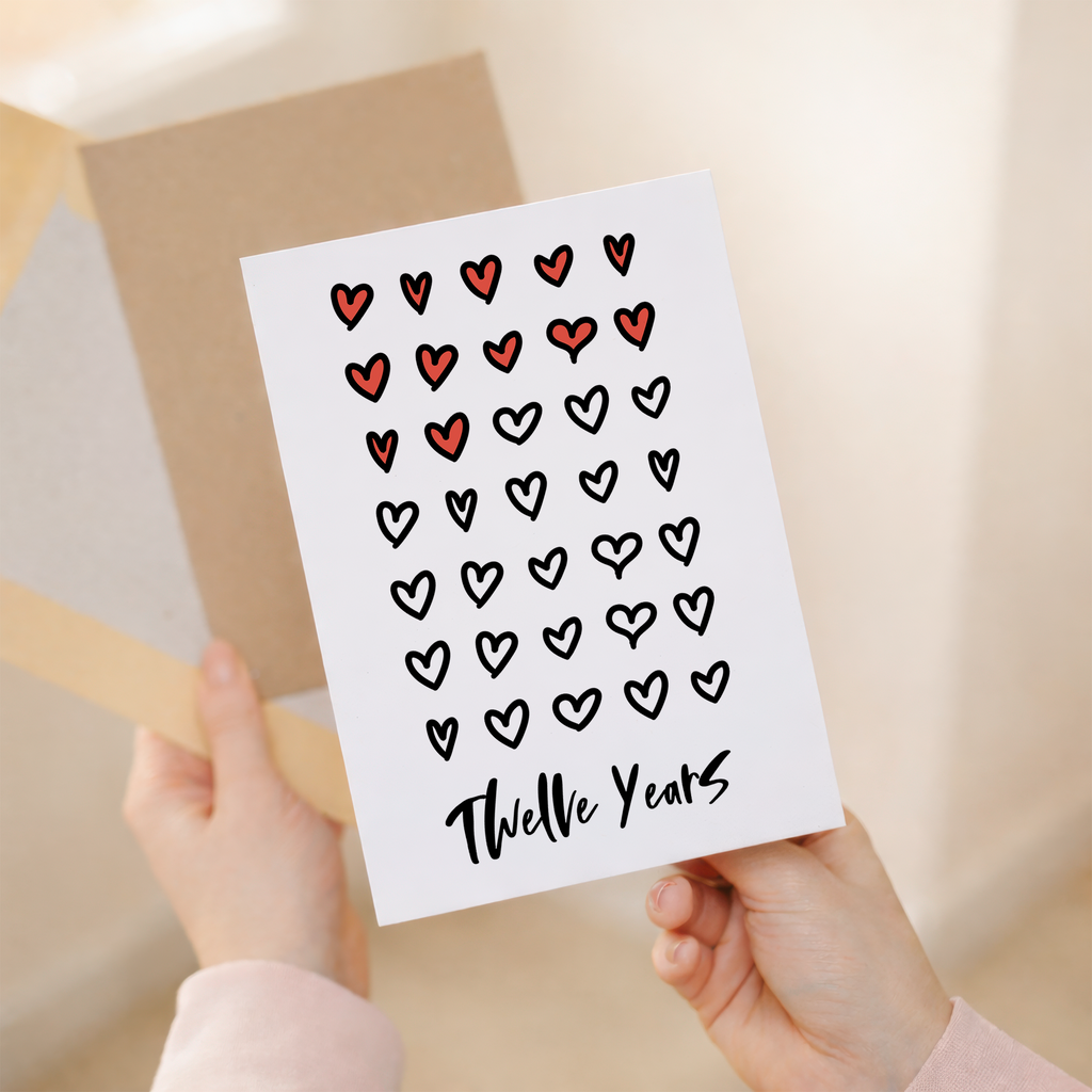 Elegant 12th Wedding Anniversary greeting card for a spouse or partner featuring a minimalist design on eco-friendly recycled cardstock, accompanied by a rustic brown Kraft envelope.