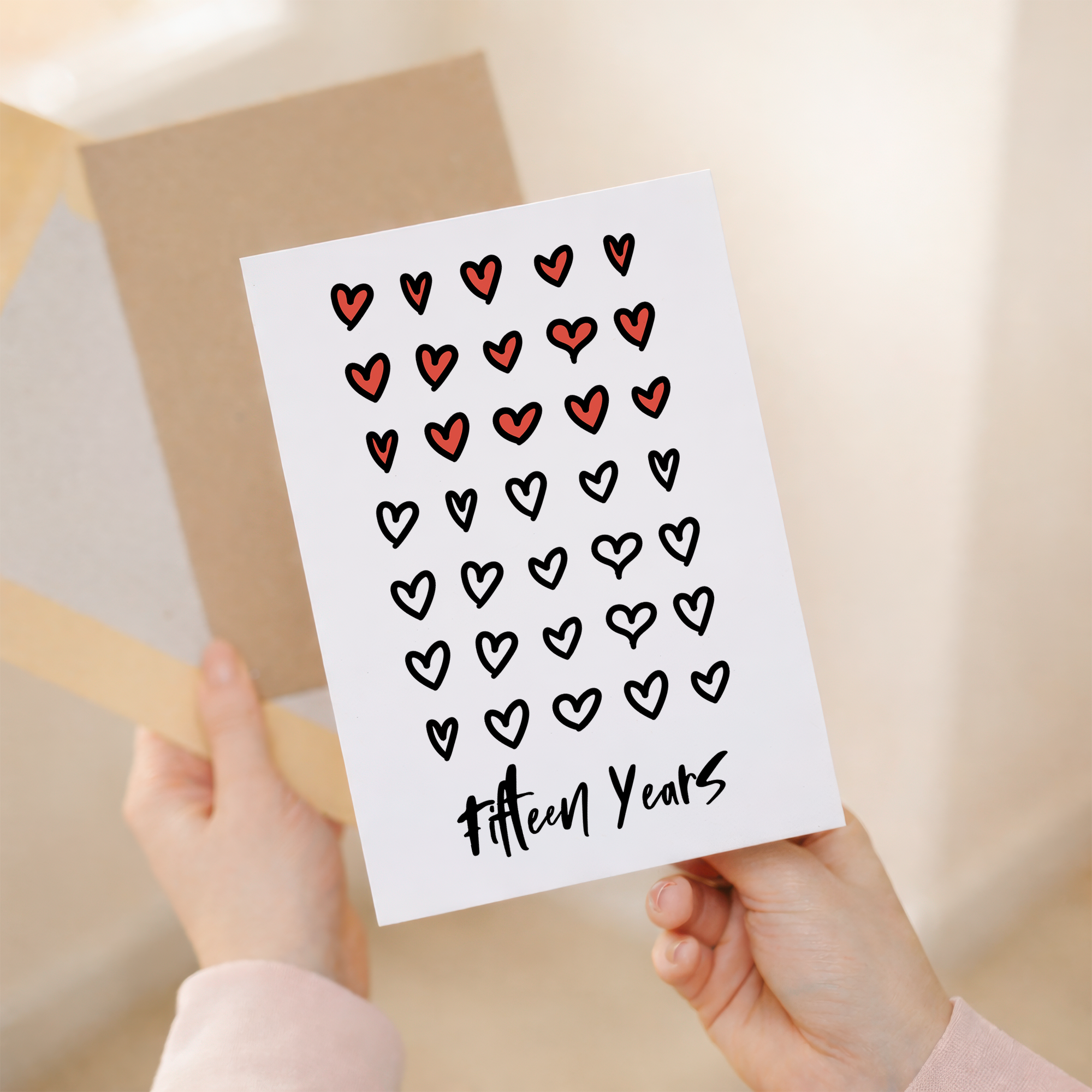 Elegant 15th wedding anniversary greeting card featuring a minimalist design on sustainable recycled cardstock, paired with a rustic brown Kraft envelope.