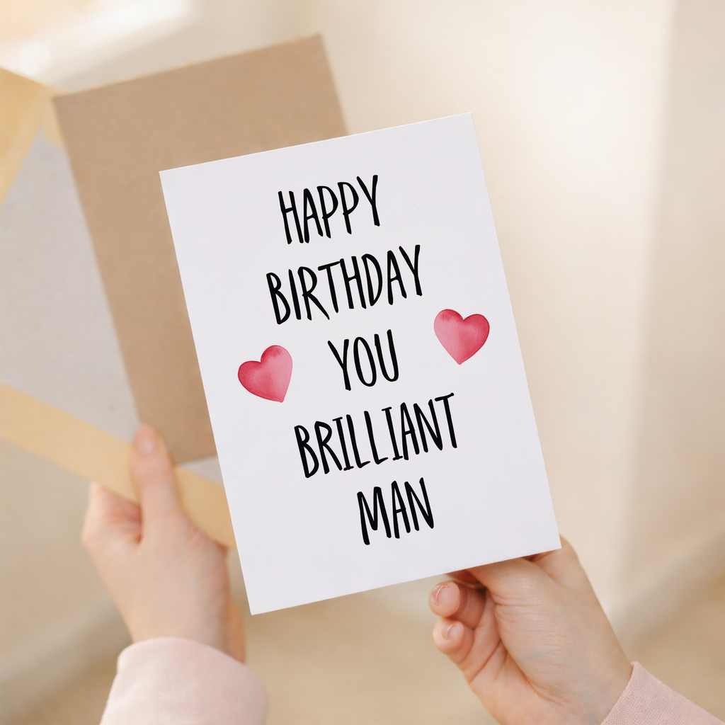 Minimalist birthday greeting card featuring the text "To a Brilliant Man" in bold, dark typography on a clean white background, accompanied by a rustic brown Kraft envelope.