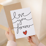 Elegant anniversary or Valentine's Day greeting card featuring the message Love You Forever in stylish script on sustainable cardstock, paired with a brown Kraft envelope.