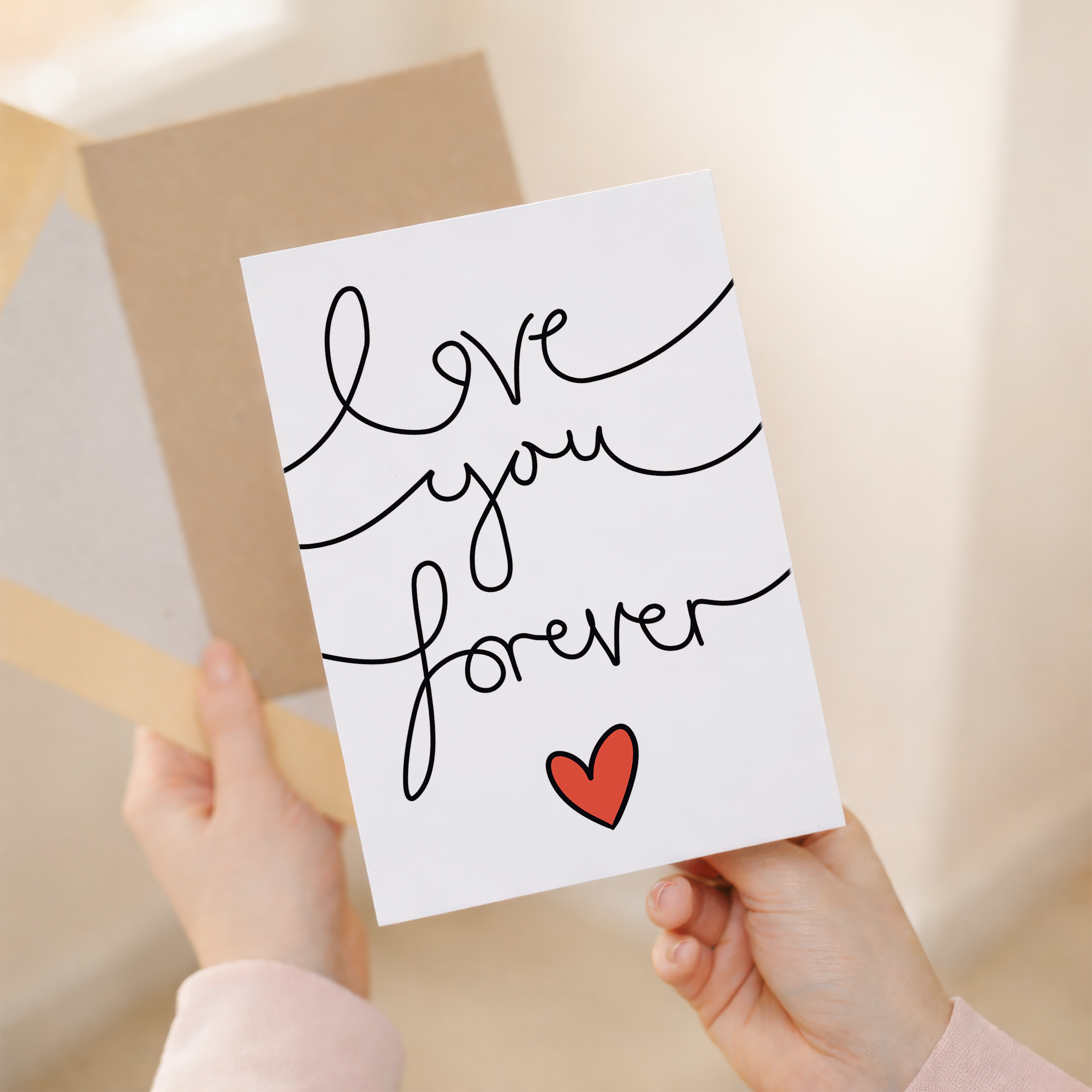 Elegant anniversary or Valentine's Day greeting card featuring the message Love You Forever in stylish script on sustainable cardstock, paired with a brown Kraft envelope.