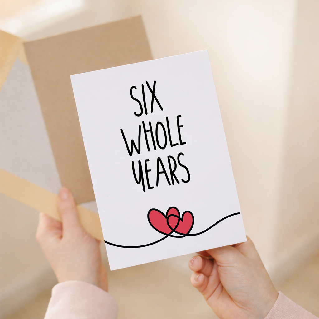 Charming 6th anniversary greeting card featuring a central heart illustration with floral patterns on eco-friendly cardstock, accompanied by a brown Kraft envelope.