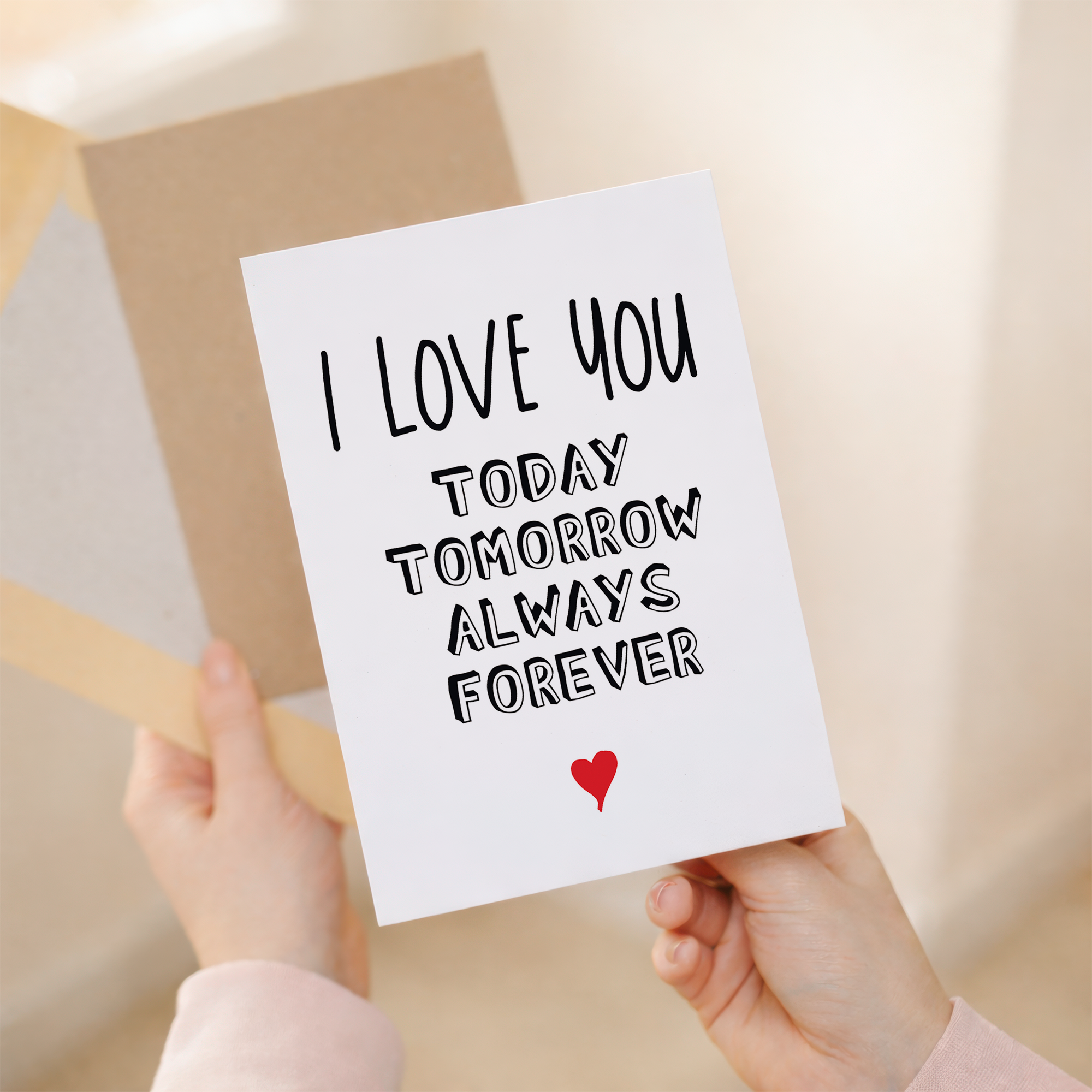 Elegant anniversary greeting card featuring a modern minimalist design with black, red, and white accents on sustainable recycled cardstock, paired with a brown Kraft envelope.
