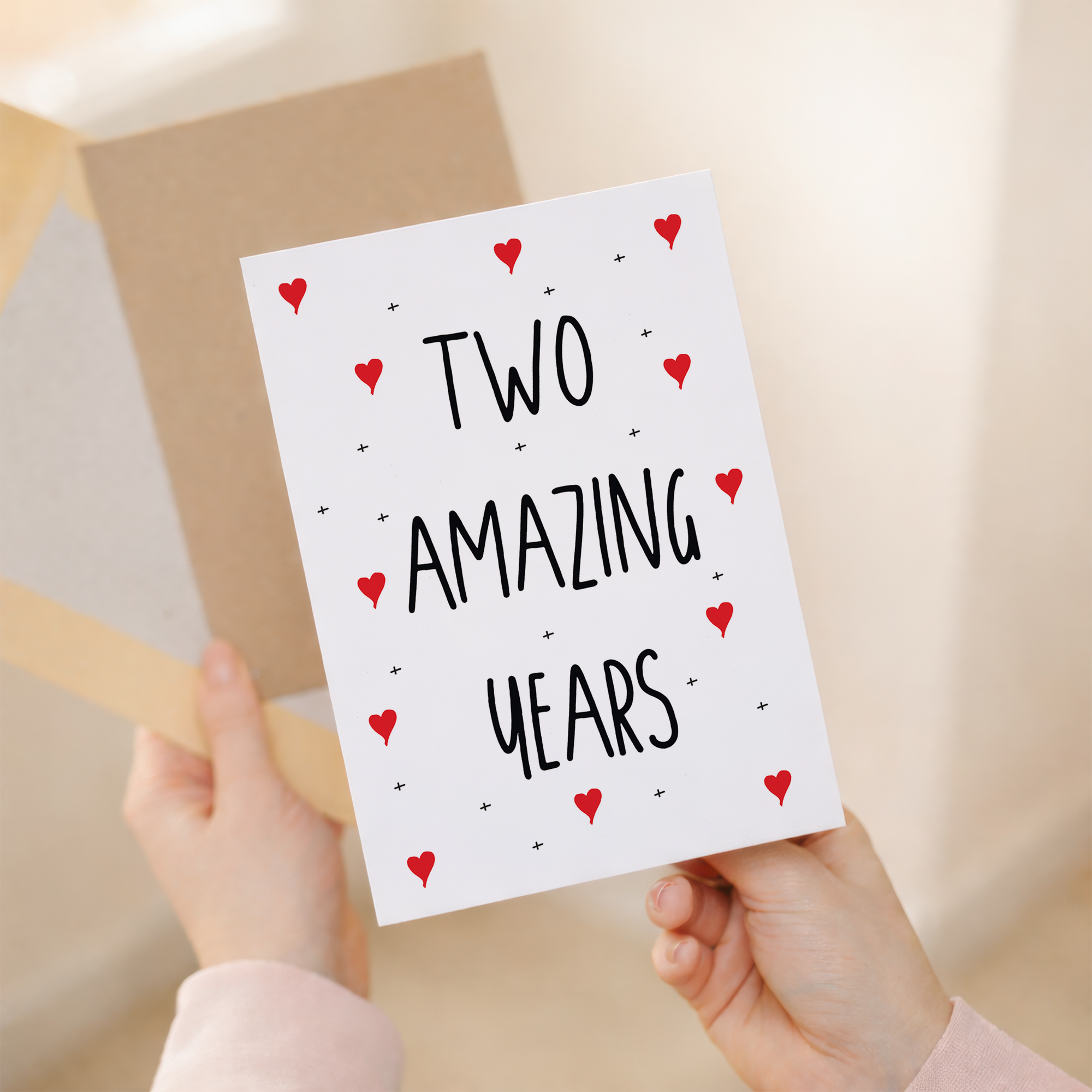 Heartfelt 2nd anniversary greeting card featuring elegant typography on sustainable recycled cardstock, paired with a brown Kraft envelope.
