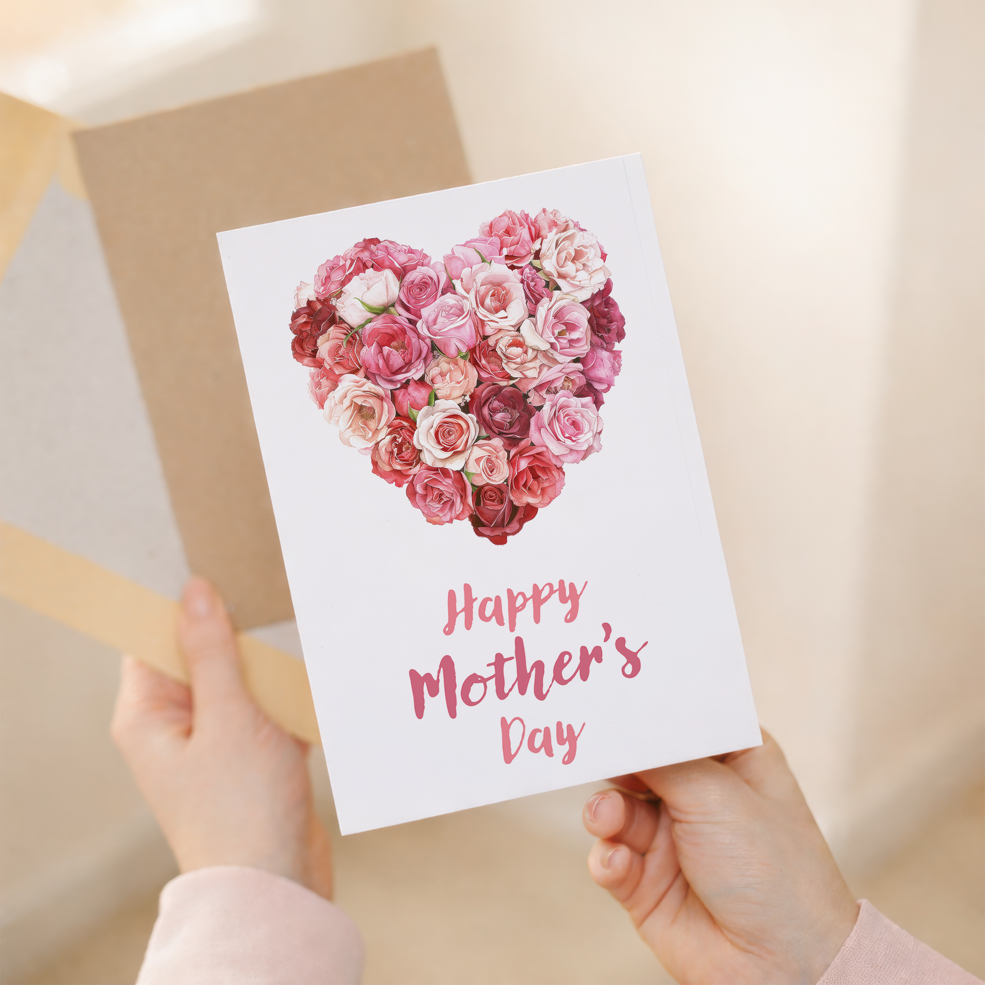 Mother's Day greeting card featuring a large heart composed of red and pink roses on a white background.