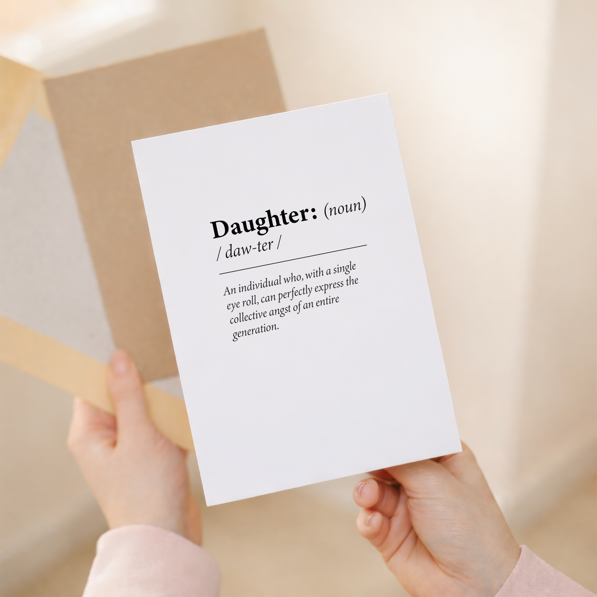 Fun dictionary-themed birthday card for a daughter featuring a humorous definition of the word Daughter on sustainable recycled cardstock, paired with a brown Kraft envelope.