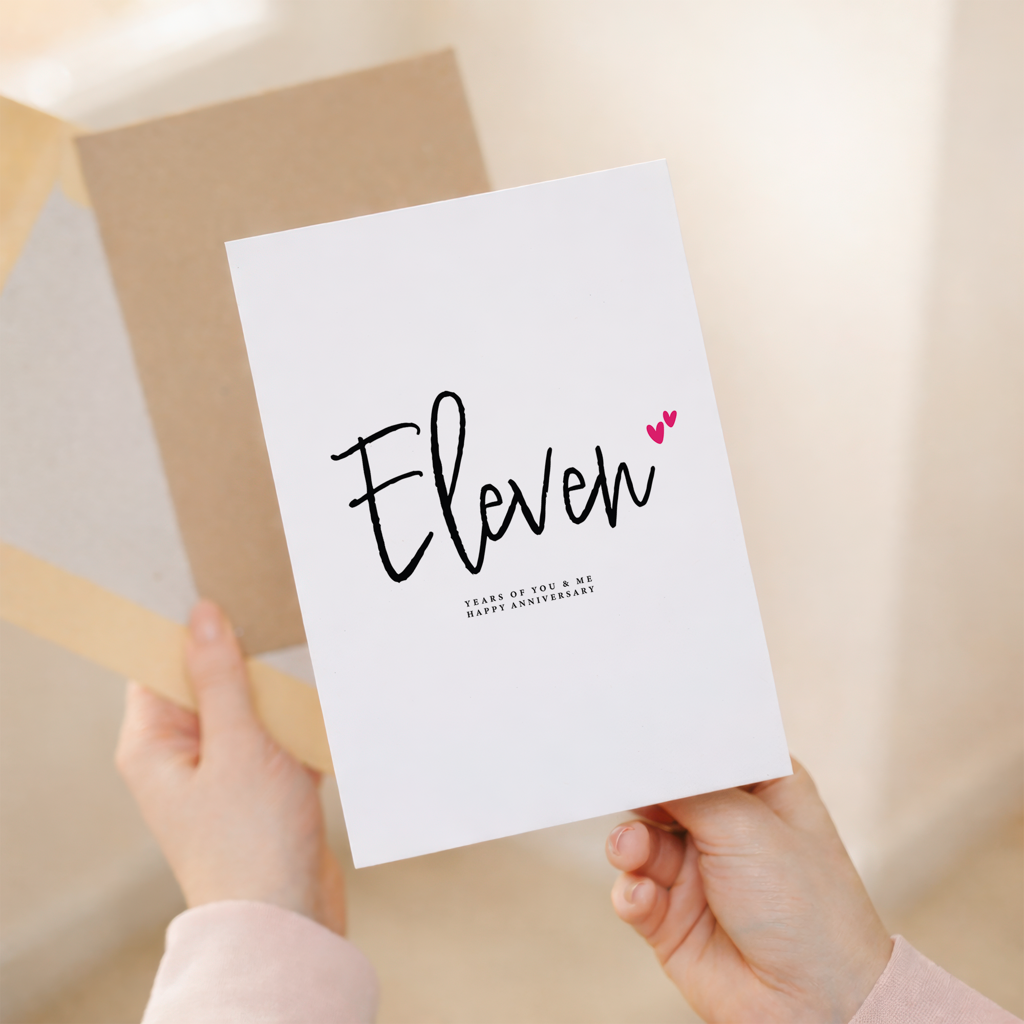 An elegant 11th Wedding Anniversary greeting card featuring a modern letters and numbers design on a white background.