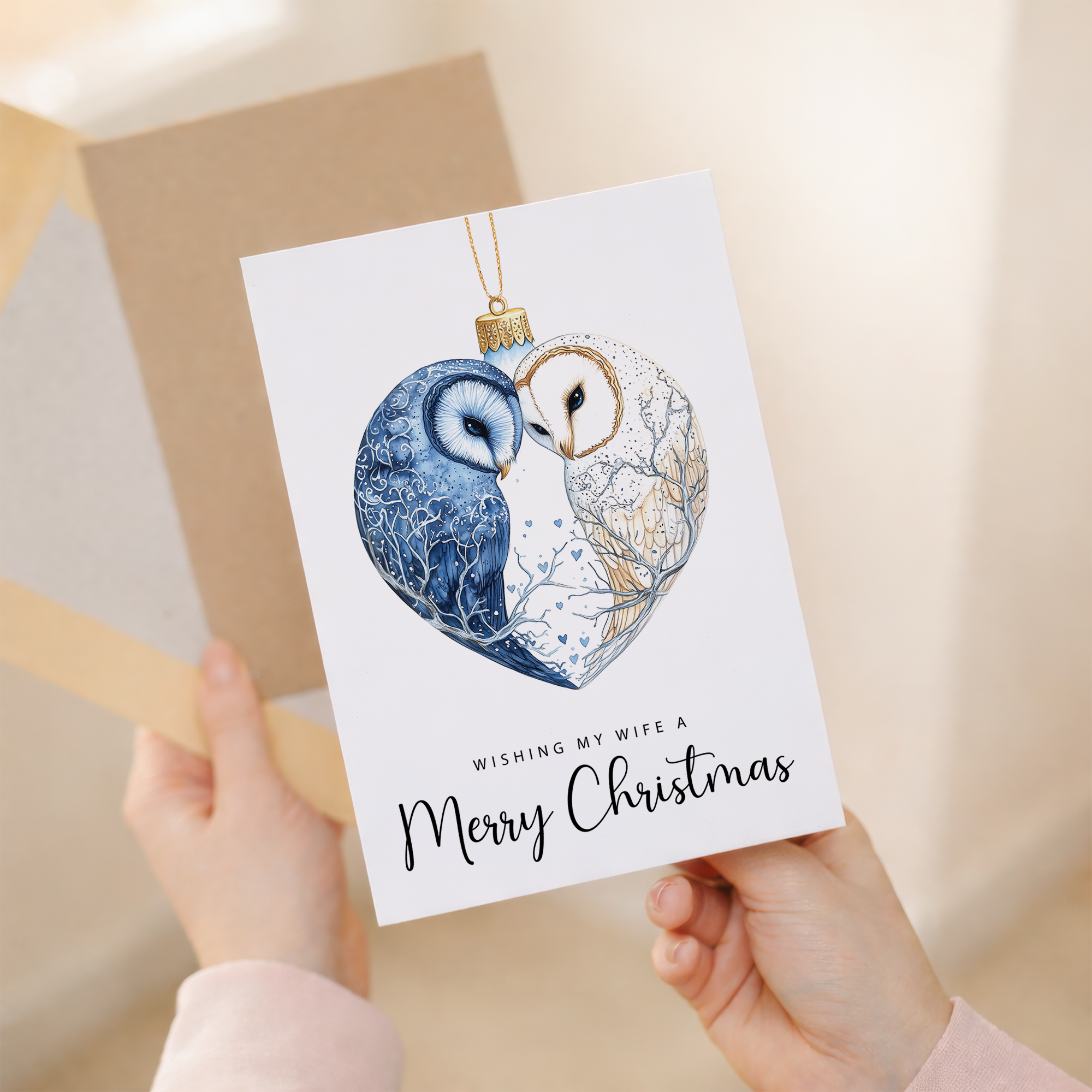Romantic Christmas card for a wife featuring an owl couple inside a bauble with a red heart and festive illustrations.