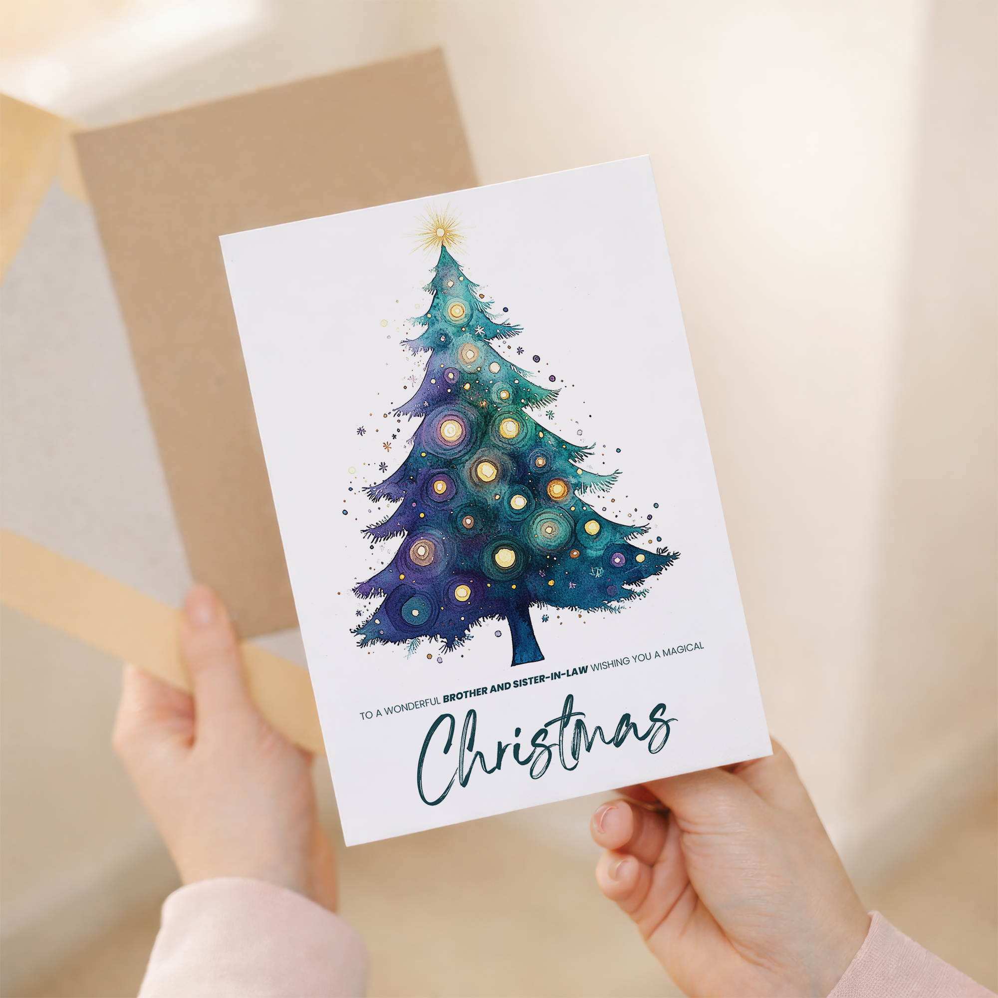 A watercolour Christmas card for a brother and sister-in-law featuring a festive green Christmas tree decorated with a gold star and colorful ornaments.