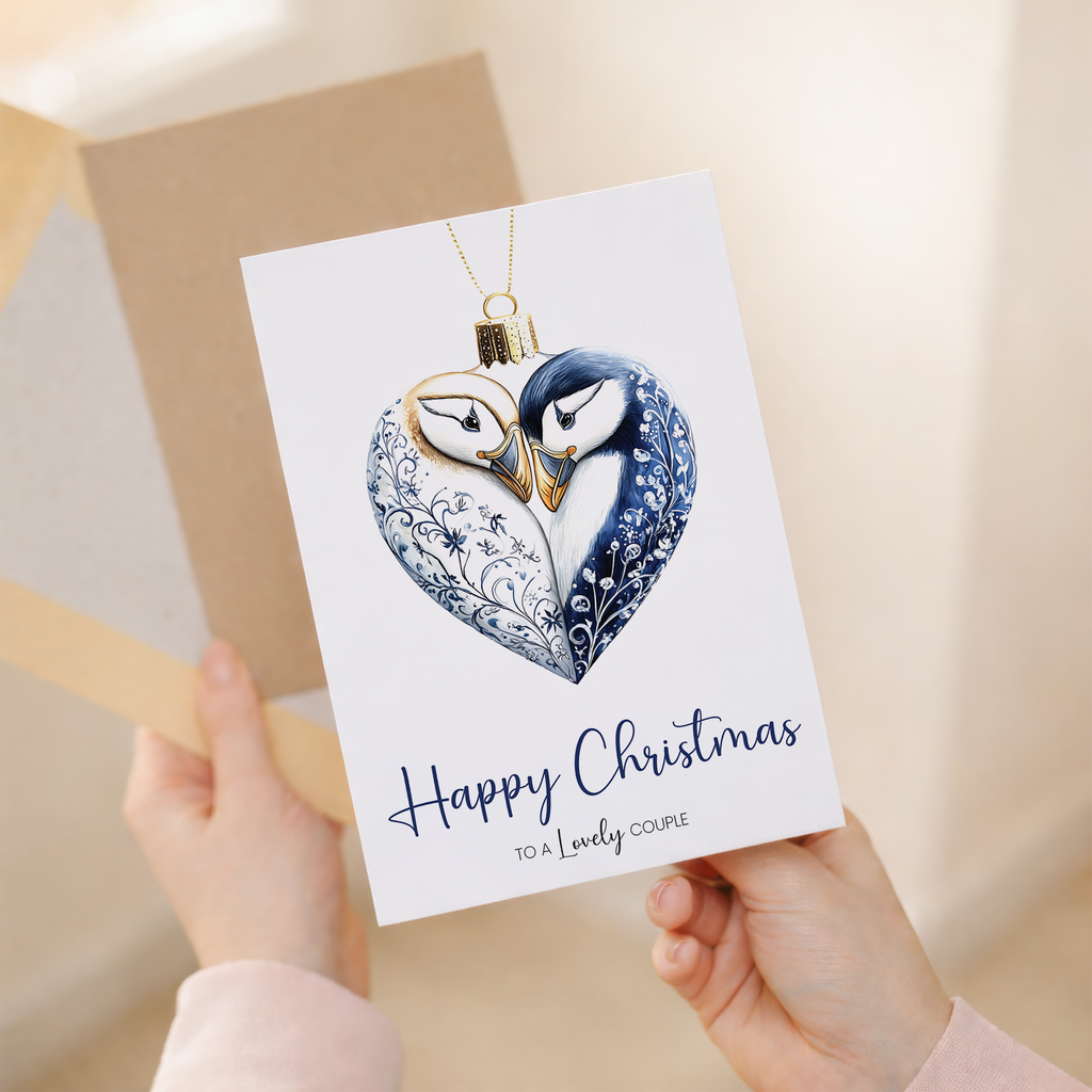 Christmas greeting card for a couple featuring a decorative holiday bauble with a puffin illustration.