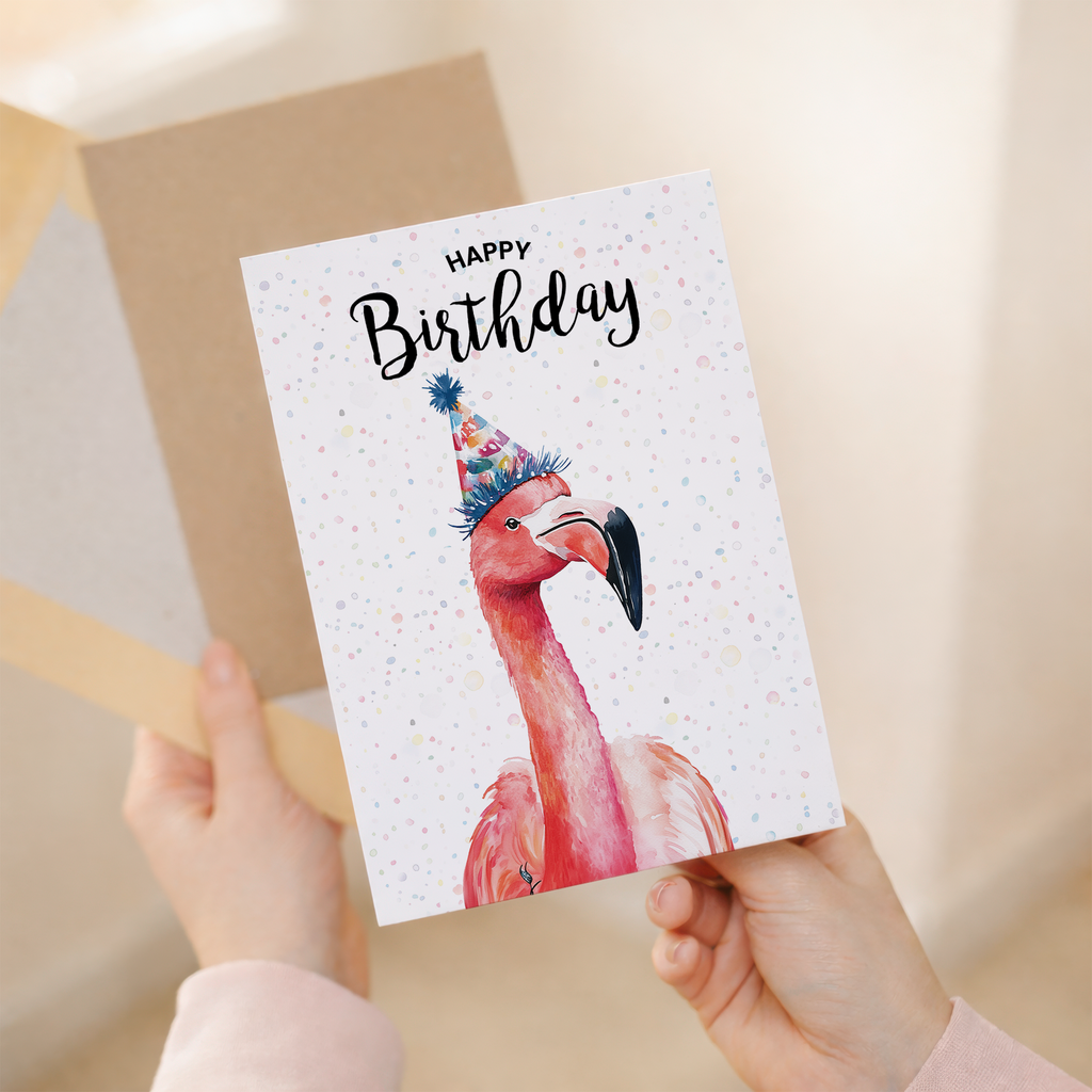 Watercolour illustration of a pink flamingo on a 5x7 birthday card.