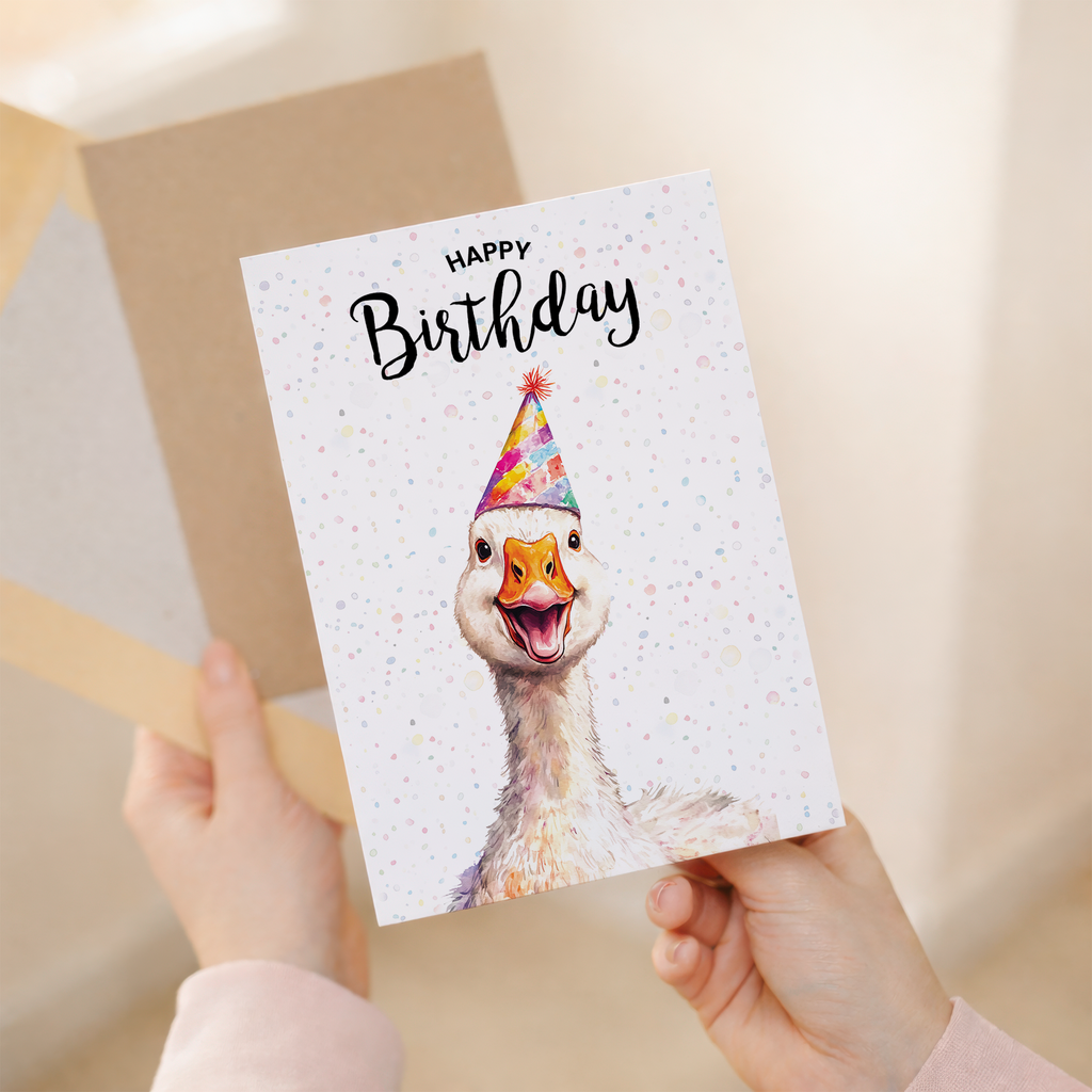 Whimsical watercolor illustration of a white goose wearing a colorful party hat on a 5x7 greeting card.
