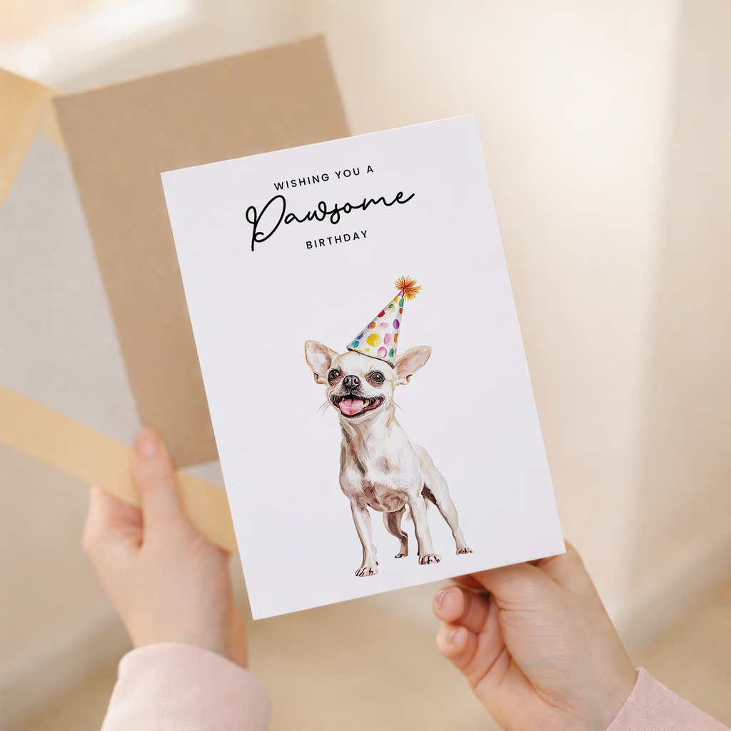 A cute Chihuahua wearing a colorful party hat on a birthday greeting card for dog lovers.