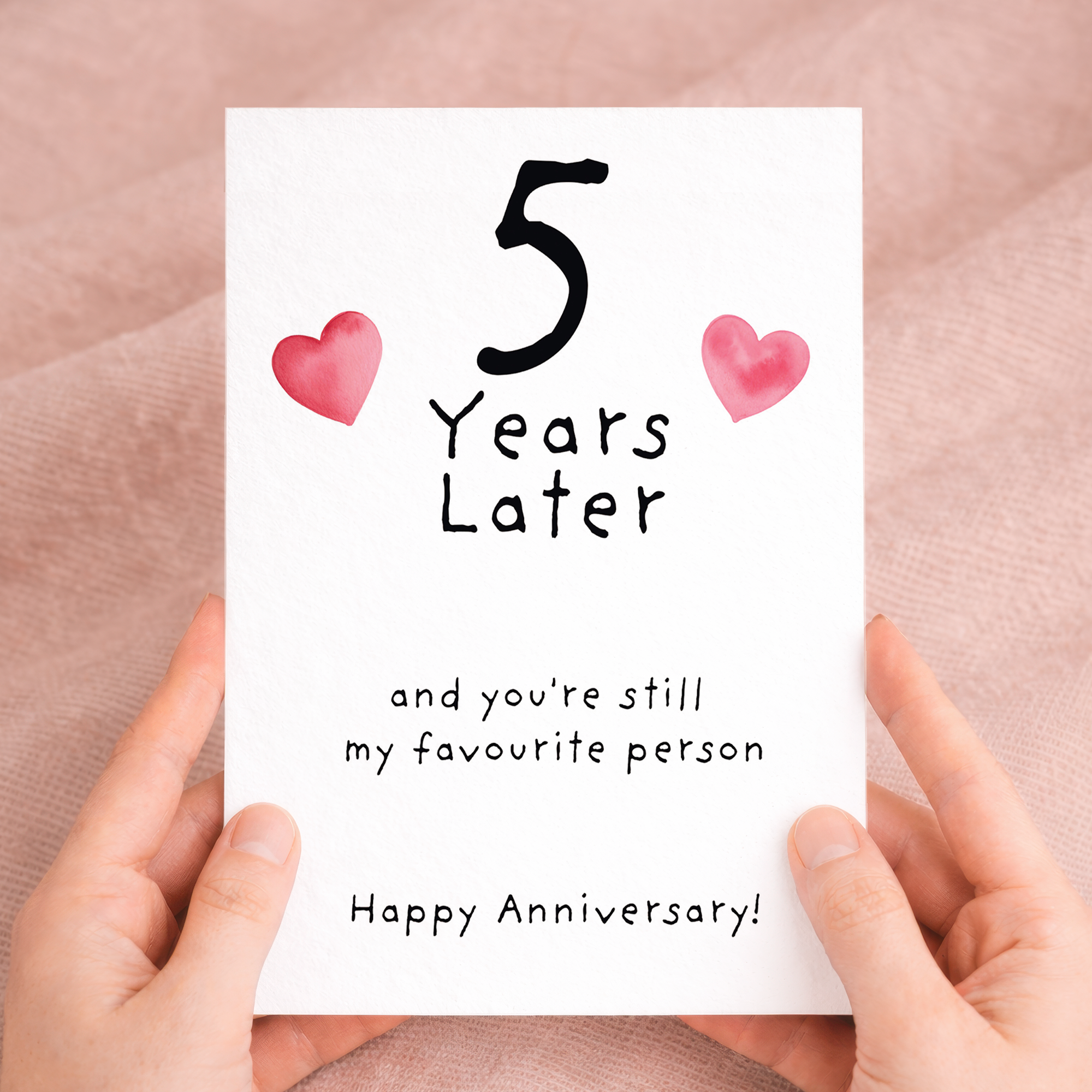 Elegant 5th wedding anniversary greeting card featuring a large number five decorated with blue floral patterns, paired with a brown kraft envelope on a wooden background.