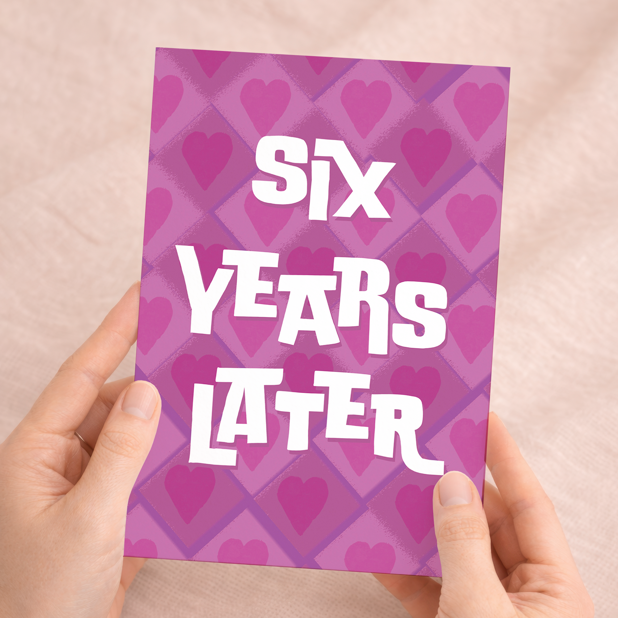 A simple and modern 5x7 inch 6th wedding anniversary card featuring elegant pink, white, and purple design elements on sustainable recycled cardstock, paired with a brown Kraft envelope.