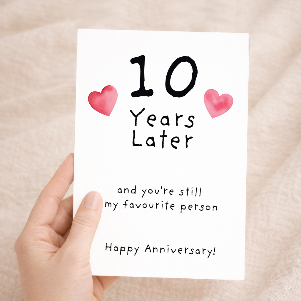Charming 10th wedding anniversary greeting card crafted from sustainable recycled cardstock with natural specks and dots, paired with a brown kraft envelope.