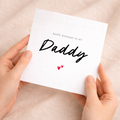 A simple and cute birthday greeting card for Daddy featuring a minimalist love hearts design on a white background.