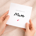 A simple and cute birthday greeting card for Mum featuring a charming love hearts design on a white background.