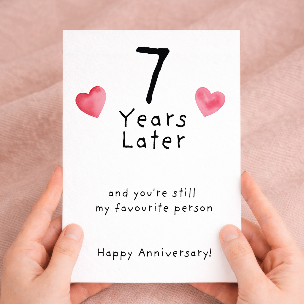 Handmade 7th wedding anniversary card featuring elegant text and floral details on recycled cardstock, paired with a rustic brown Kraft envelope.