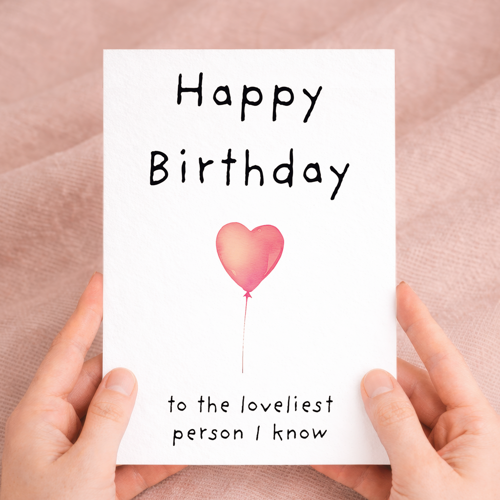 Charming birthday greeting card featuring a central floral heart illustration on sustainable recycled cardstock, paired with a brown Kraft envelope.