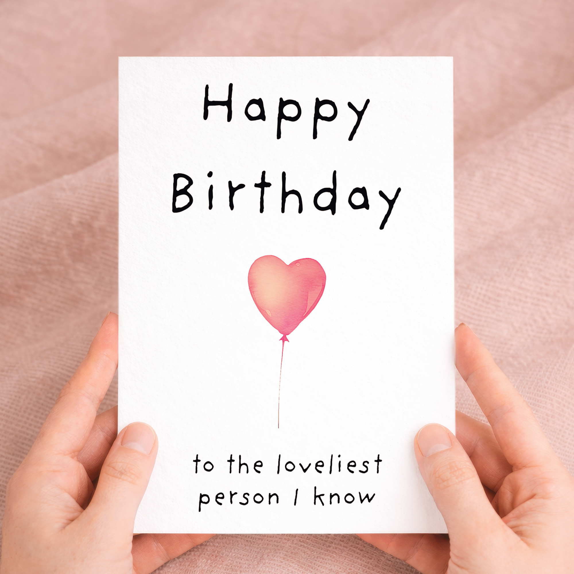 Charming birthday greeting card featuring a central floral heart illustration on sustainable recycled cardstock, paired with a brown Kraft envelope.