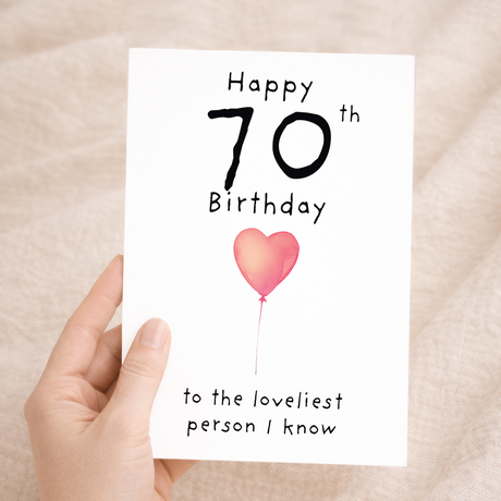 Elegant 70th birthday greeting card for her featuring a vibrant "70" with floral accents on eco-friendly cardstock, accompanied by a brown Kraft envelope.