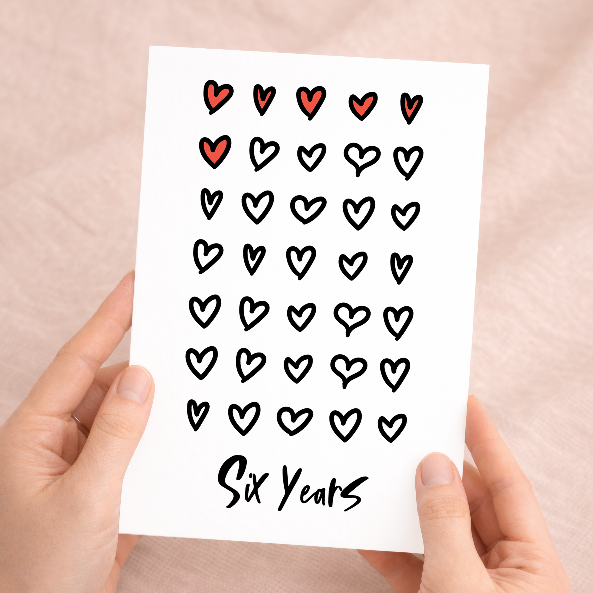 Elegant 6th wedding anniversary greeting card with a minimalist heart design on eco-friendly recycled cardstock, accompanied by a rustic brown Kraft envelope.