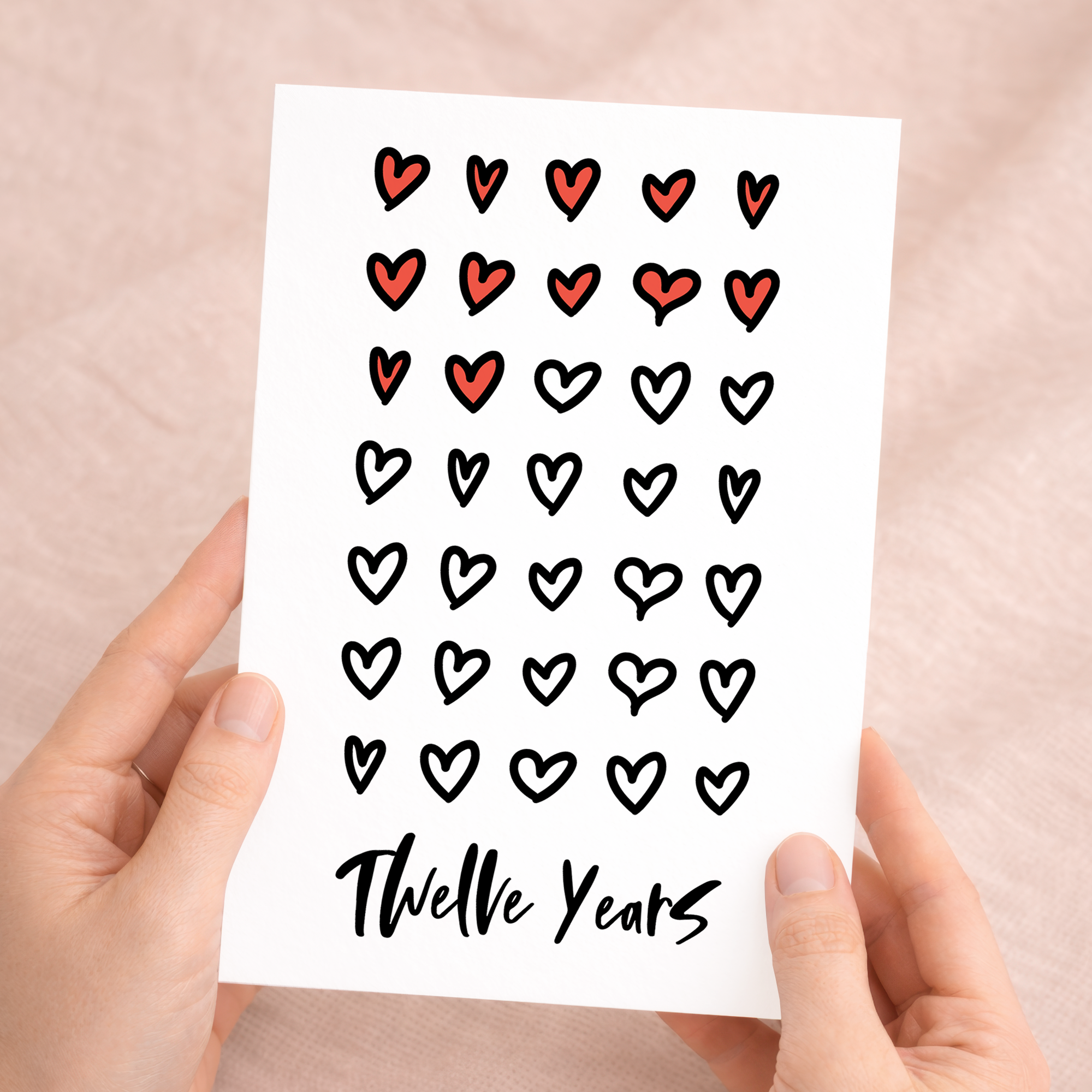 Elegant 12th Wedding Anniversary greeting card for a spouse or partner featuring a minimalist design on eco-friendly recycled cardstock, accompanied by a rustic brown Kraft envelope.