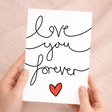 Elegant anniversary or Valentine's Day greeting card featuring the message Love You Forever in stylish script on sustainable cardstock, paired with a brown Kraft envelope.