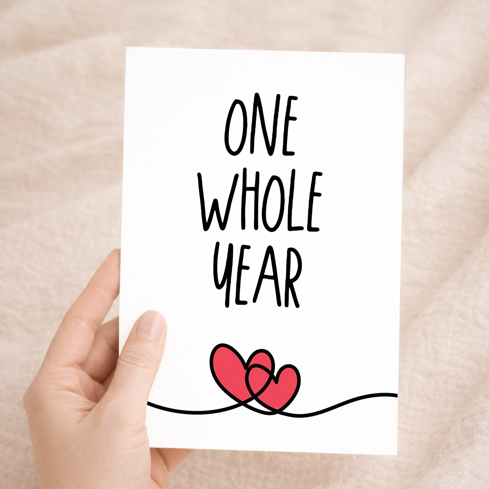 Minimalist 1st anniversary greeting card featuring a simple heart and elegant typography on eco-friendly cardstock, accompanied by a rustic brown Kraft envelope.
