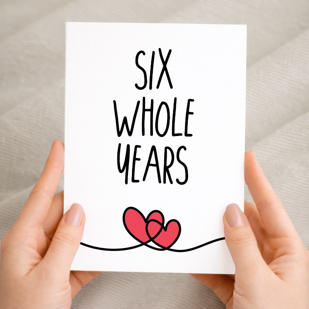 Charming 6th anniversary greeting card featuring a central heart illustration with floral patterns on eco-friendly cardstock, accompanied by a brown Kraft envelope.