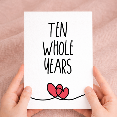 Elegant 10th anniversary greeting card featuring a "10 Years" design on sustainable recycled cardstock, paired with a brown Kraft envelope.