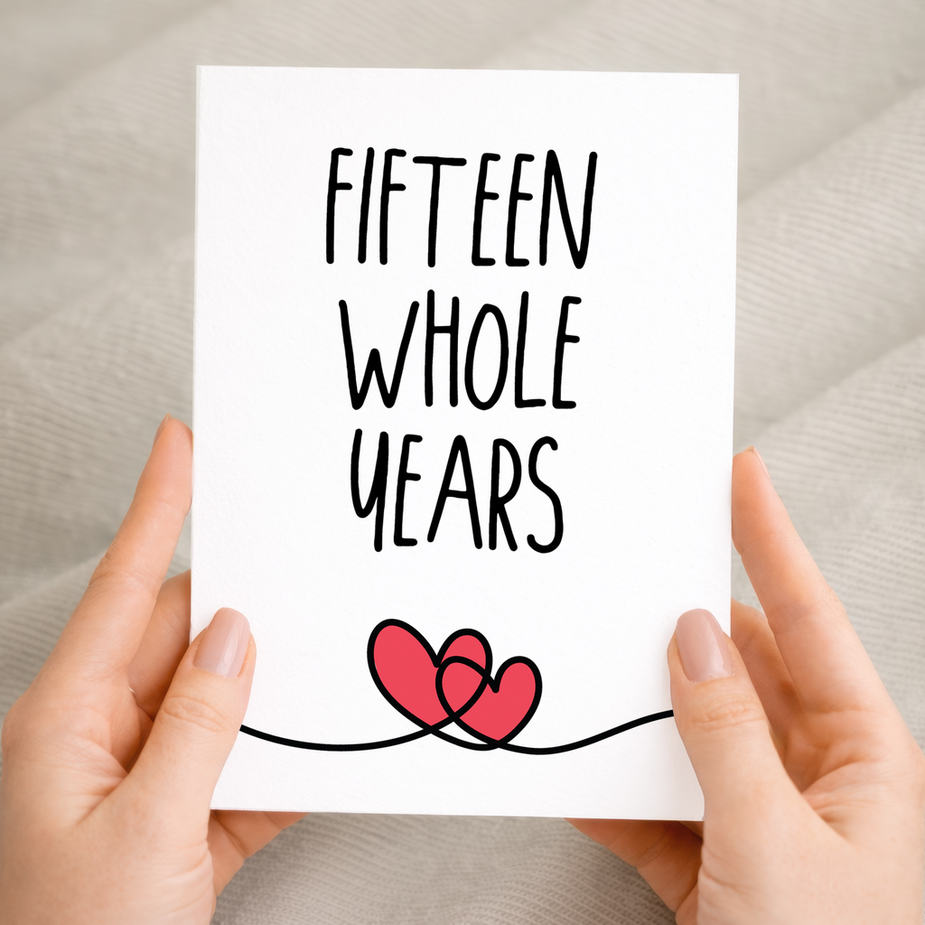Elegant 15th anniversary greeting card featuring a minimalist heart design on sustainable recycled cardstock, accompanied by a rustic brown Kraft envelope.