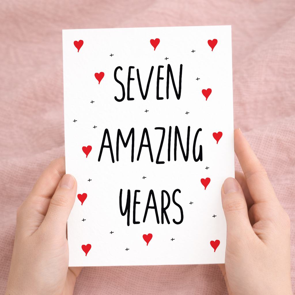 Handmade 7th anniversary greeting card featuring a minimalist heart design on sustainable recycled cardstock, paired with a rustic brown Kraft envelope.