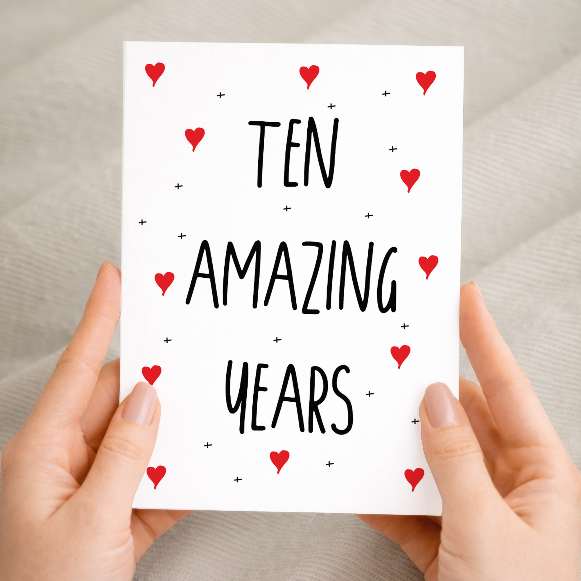 Charming 10th Anniversary greeting card on sustainable recycled cardstock with natural specks, paired with a brown Kraft envelope.