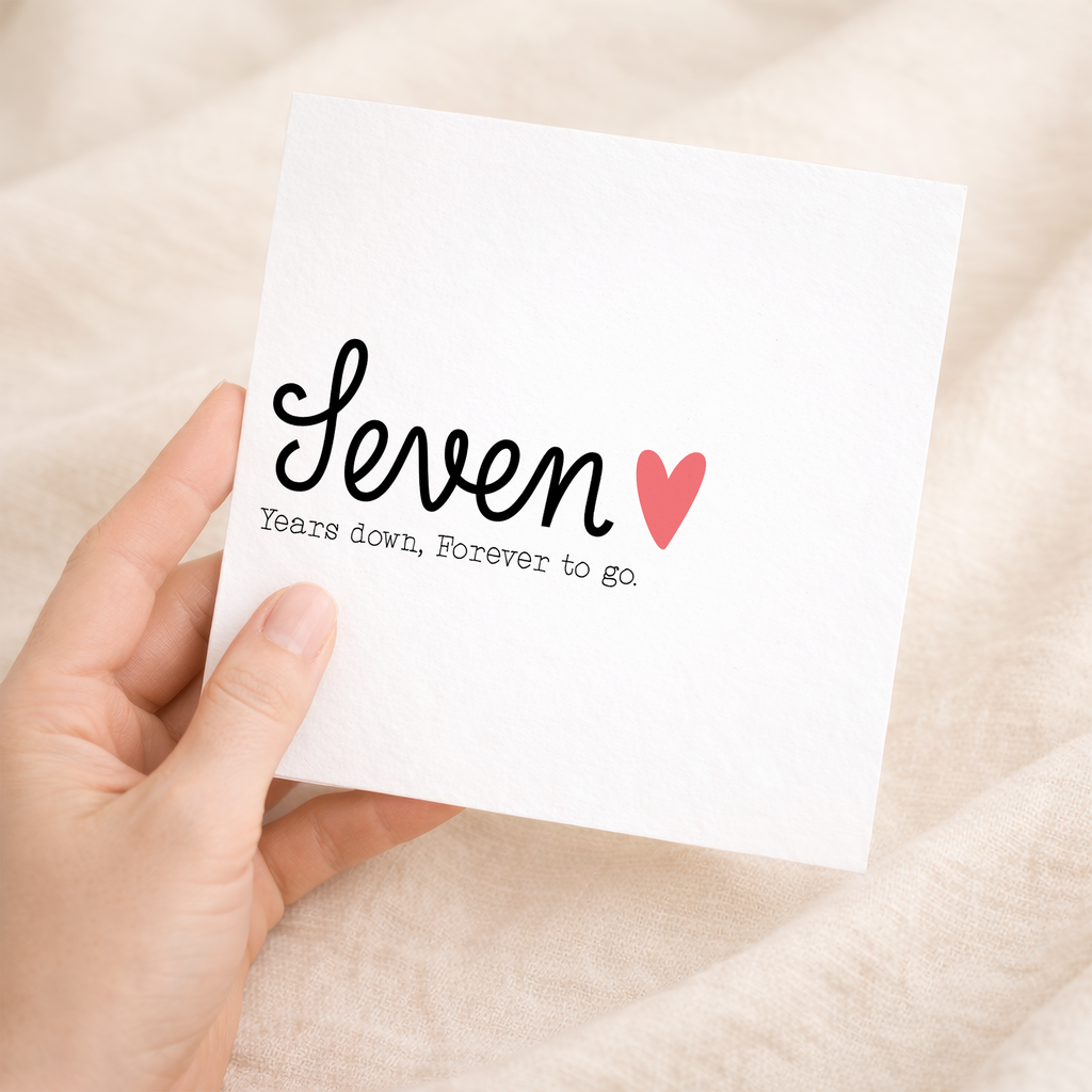 A simple and elegant 7th wedding anniversary greeting card for a wife or husband featuring a romantic design with letters and numbers on a white background.