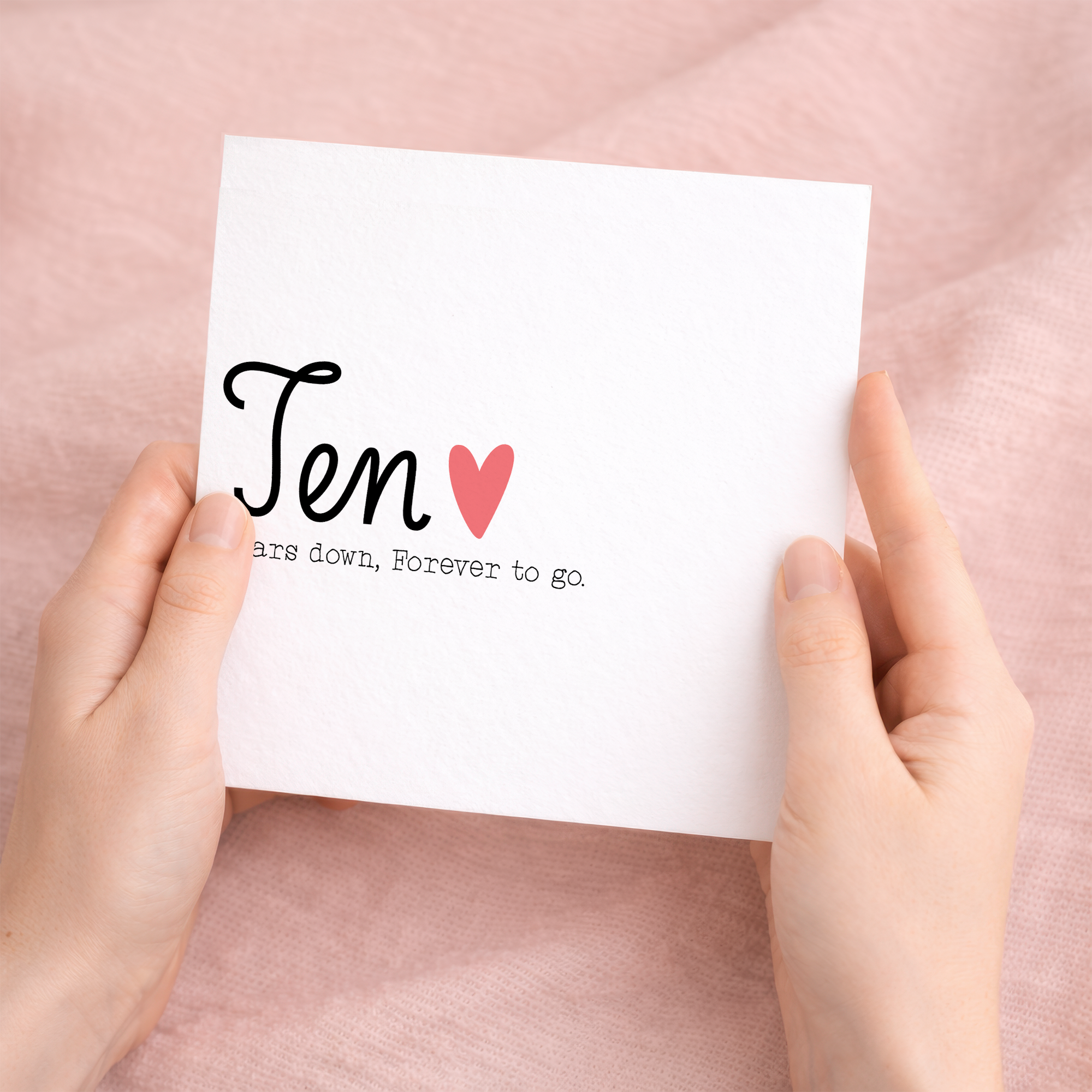 A 10th wedding anniversary greeting card for a husband or wife featuring a simple design with the number 10 and a heartfelt message on a white background.