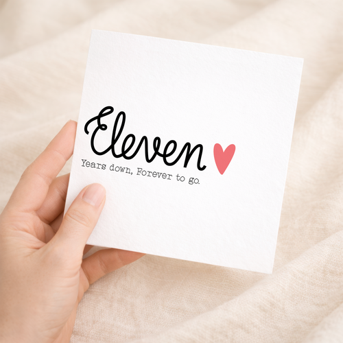 An 11th wedding anniversary greeting card featuring a simple and elegant typography design on a white background.