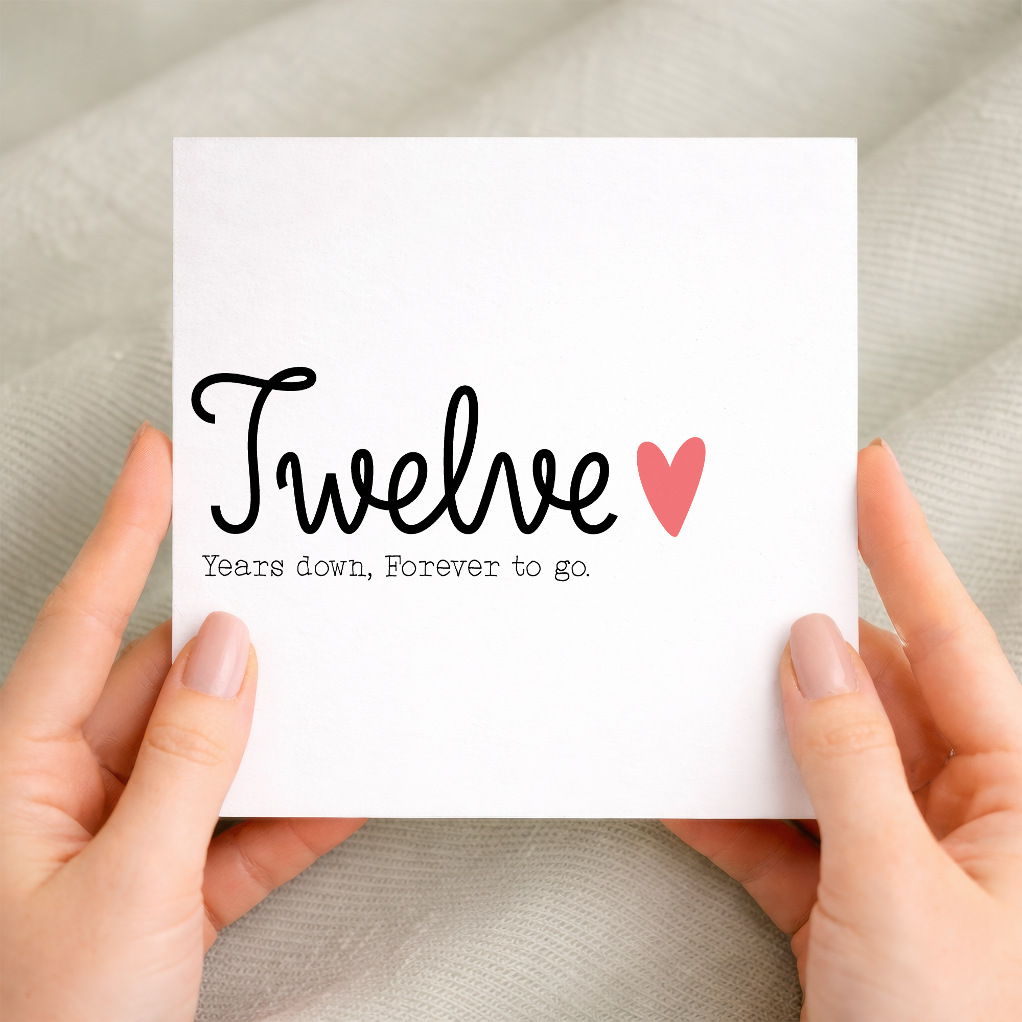A simple 12th wedding anniversary greeting card for a husband or wife featuring a number 12 design on a white background.