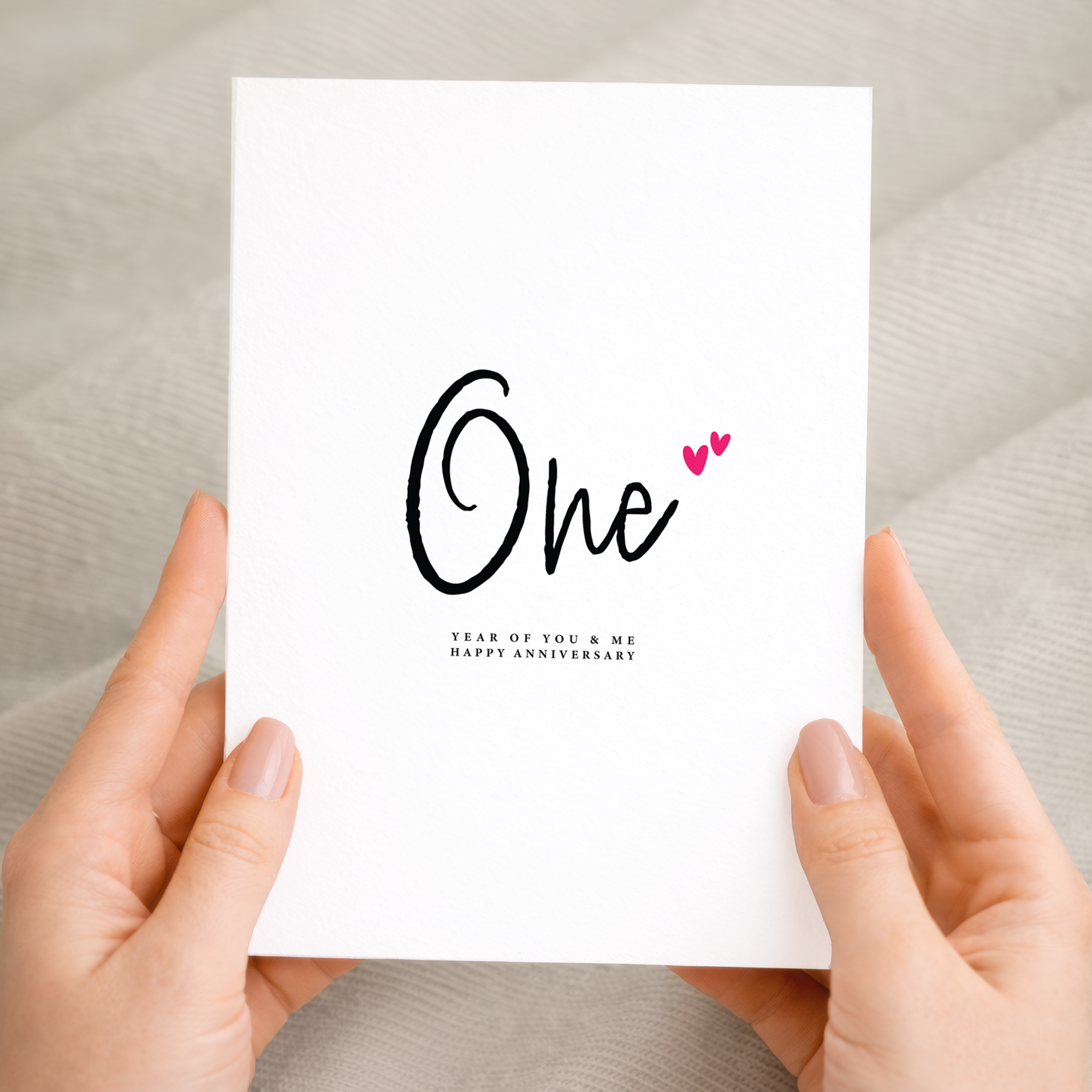 A romantic one year anniversary greeting card featuring a simple letters and numbers design on a white background.